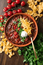Hearty black bean and quinoa chili with avocado slices