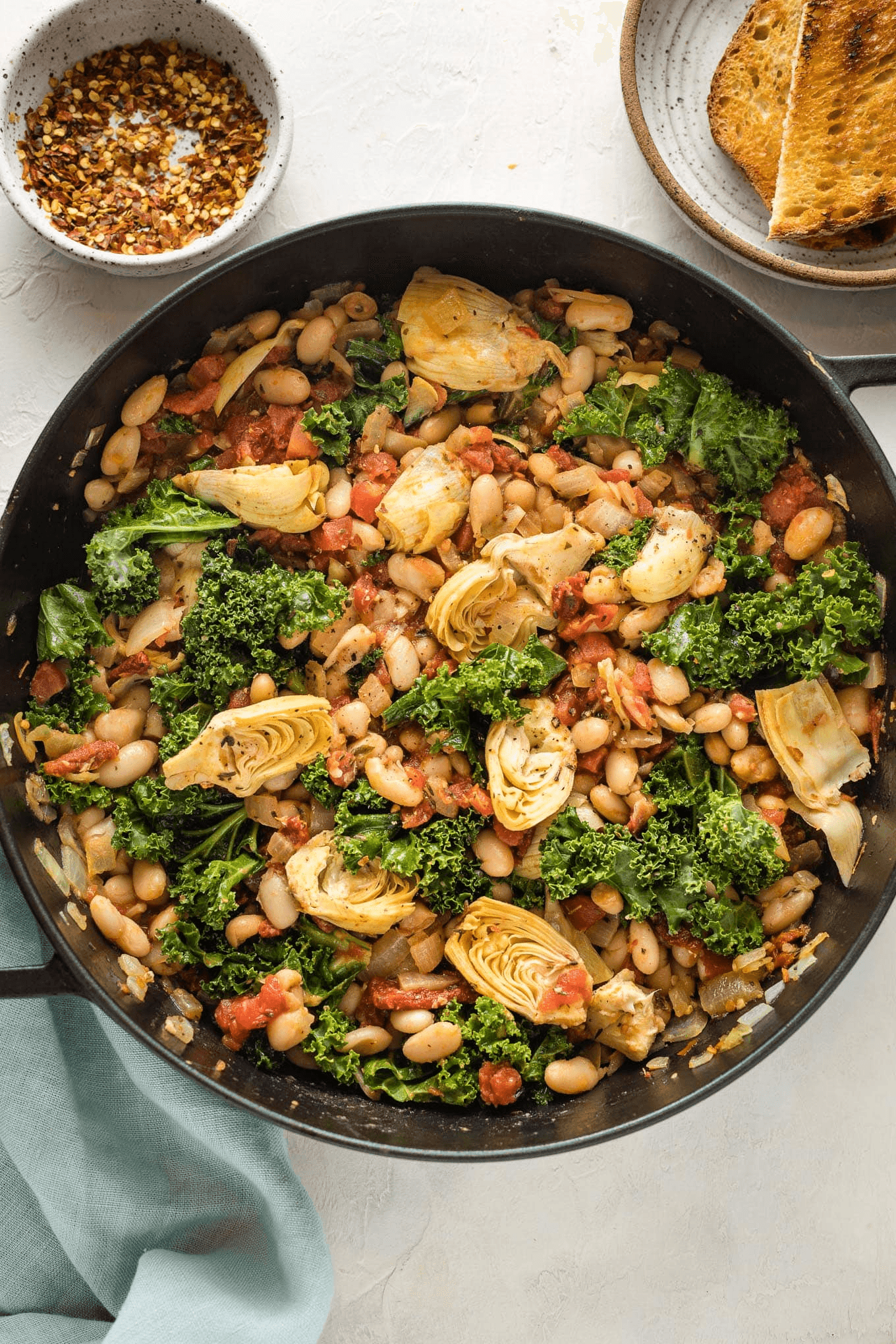 Seared chicken thighs with cannellini beans and spinach in tomato sauce
